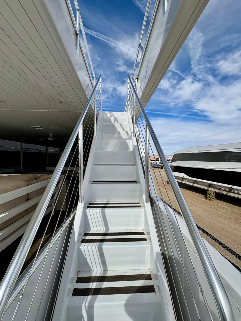 Slide: The Image of Staircase on Adonia Cosmos Trip #11, 2024, under a bright blue sky. - 33