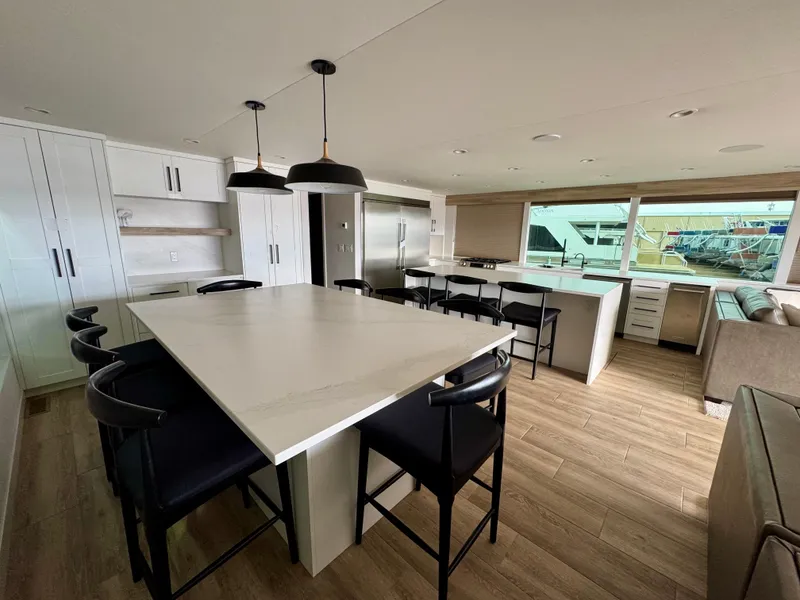 Slide: The Image of Modern kitchen interior in Adonia Cosmos Trip #11, 2024 model, featuring sleek design and ample seating. - 7