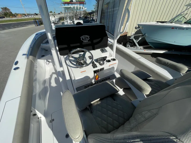Slide: The Image of 2021 Sportsman Open 282 Center Console boat interior with steering wheel and seating. - 11