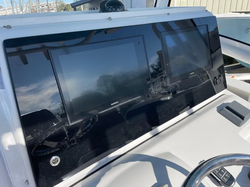 Slide: The Image of 2021 Sportsman Open 282 Center Console dashboard with dual display screens. - 12