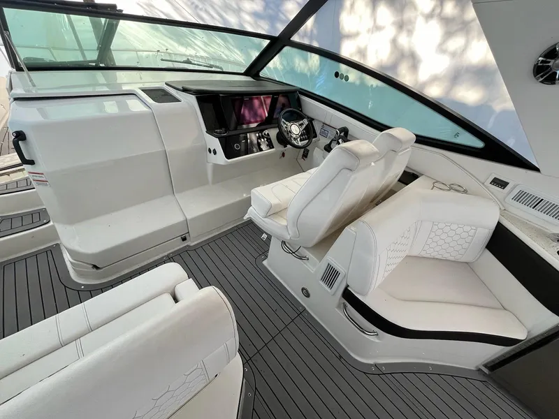 Slide: The Image of 2020 Sea Ray Sundancer 320 cockpit with modern helm and luxurious white seating. - 10