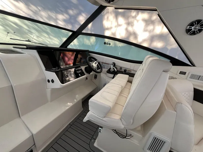 Slide: The Image of 2020 Sea Ray Sundancer 320 helm with modern controls and luxurious white seating. - 12