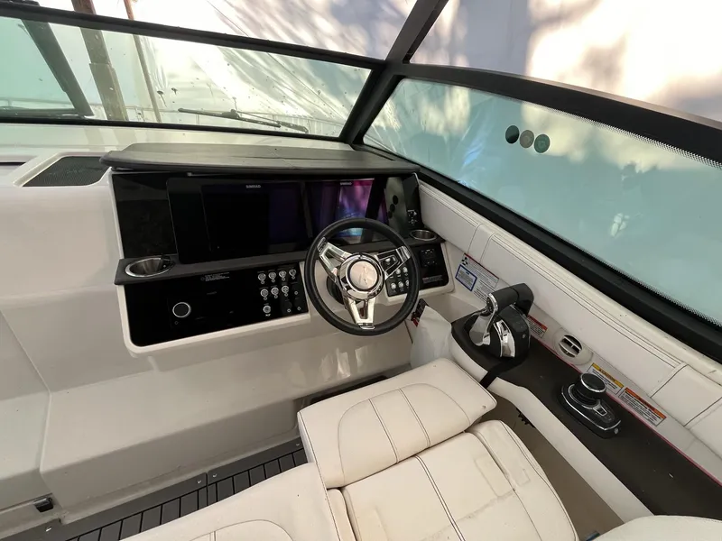 Slide: The Image of 2020 Sea Ray Sundancer 320 helm with modern controls and leather seating. - 13