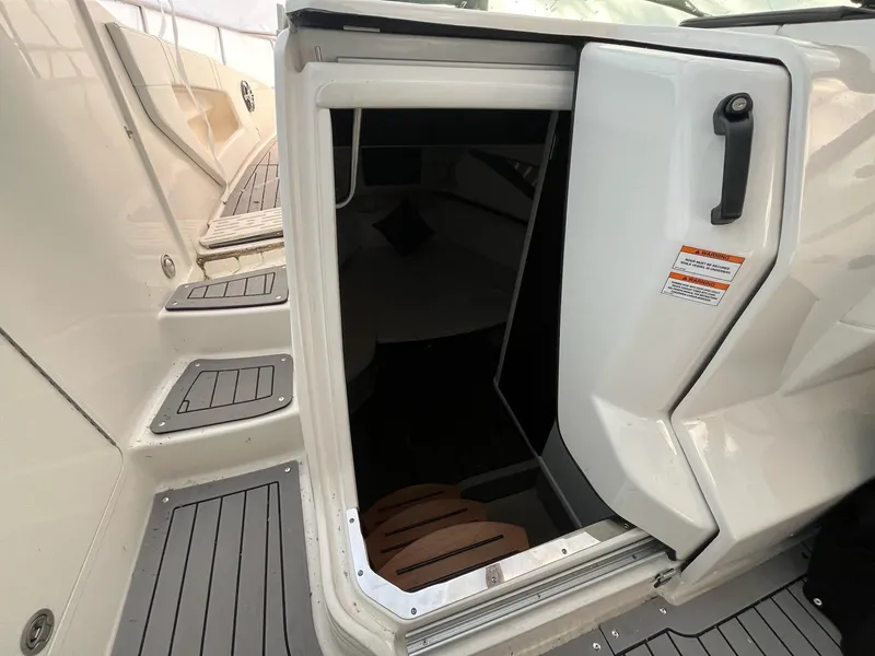 Slide: The Image of 2020 Sea Ray Sundancer 320 cabin entrance with open door and steps. - 17