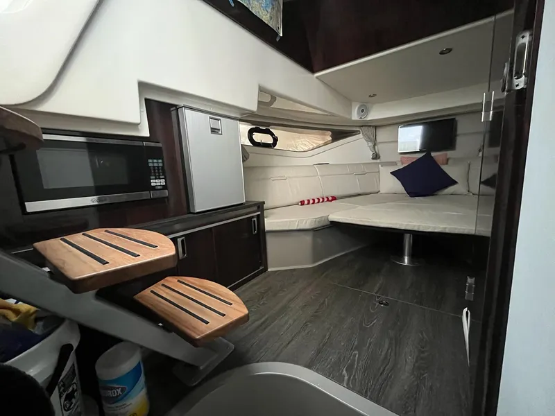 Slide: The Image of Interior of 2020 Sea Ray Sundancer 320 yacht with modern amenities and cozy seating area. - 18