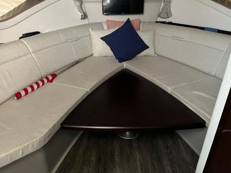 Slide: The Image of Interior of 2020 Sea Ray Sundancer 320 with cozy seating and cushions. - 20