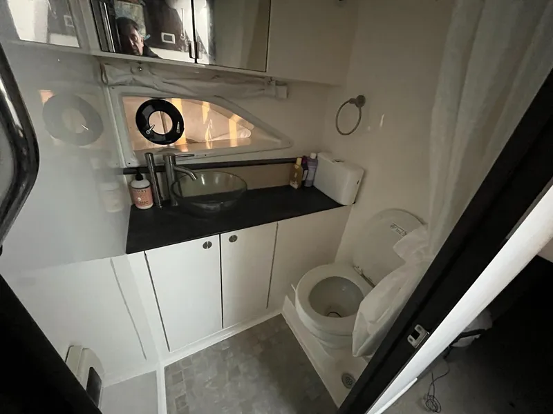 Slide: The Image of Bathroom interior of 2020 Sea Ray Sundancer 320 yacht, featuring sink and toilet. - 22