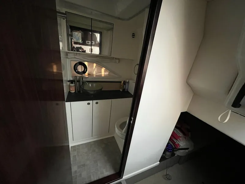 Slide: The Image of 2020 Sea Ray Sundancer 320 cabin with twin beds and modern decor. - 28