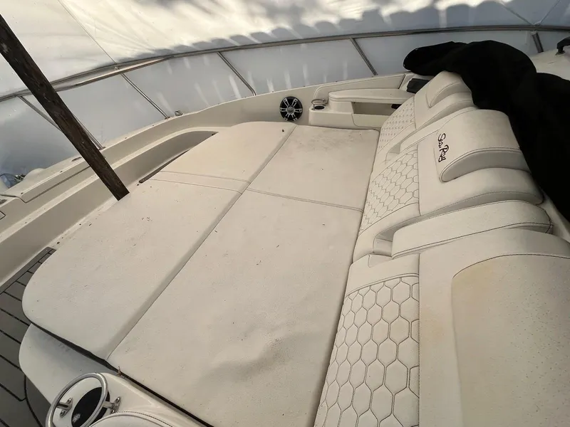 Slide: The Image of 2020 Sea Ray Sundancer 320 interior with white cushioned seating and speaker system. - 31
