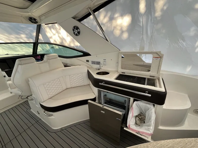 Slide: The Image of 2020 Sea Ray Sundancer 320 interior with seating, kitchenette, and modern design. - 7