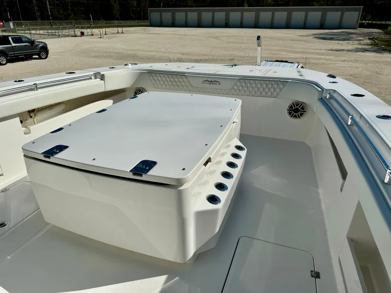 Slide: The Image of 2020 Invincible 37 Catamaran deck view with storage compartment and rod holders. - 11