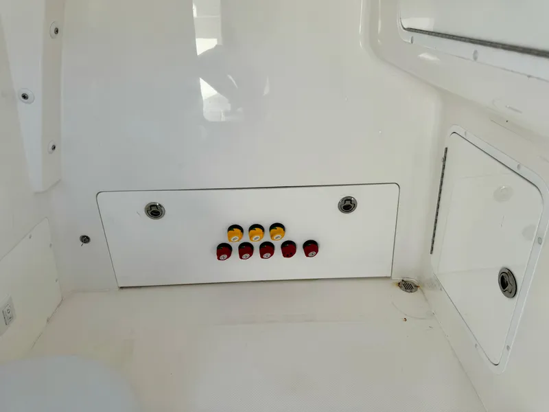 Slide: The Image of Control panel on a 2020 Invincible 37 Catamaran, featuring switches and a clean white surface. - 12
