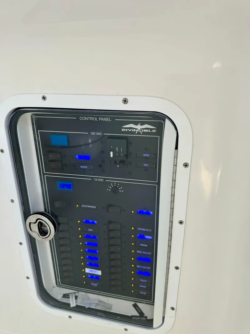 Slide: The Image of Control panel of a 2020 Invincible 37 Catamaran with illuminated switches and gauges. - 14