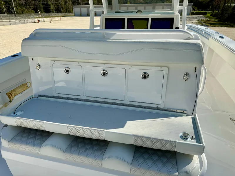 Slide: The Image of Invincible 37 Catamaran 2020, white seating area with storage compartments on deck. - 16