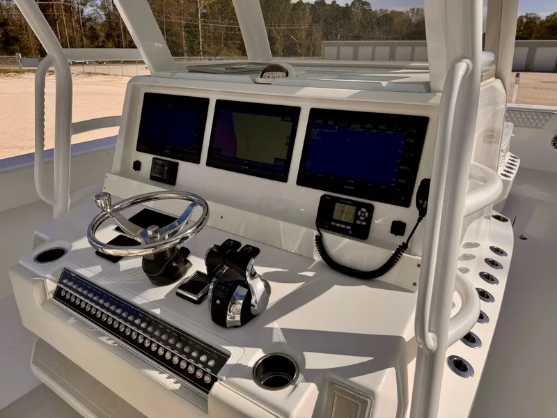 Slide: The Image of Control panel of 2020 Invincible 37 Catamaran with advanced navigation displays and steering wheel. - 18