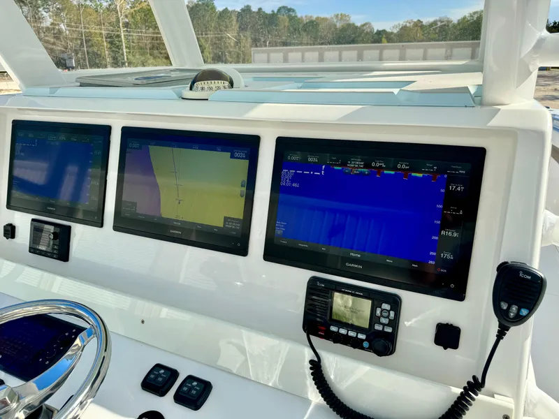 Slide: The Image of Invincible 37 Catamaran 2020 dashboard with advanced navigation displays and controls. - 19