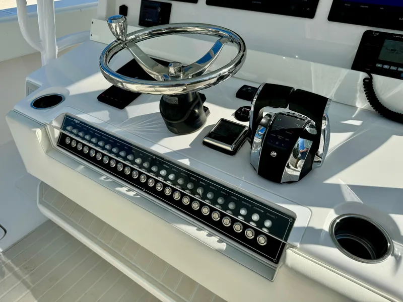 Slide: The Image of Control panel of 2020 Invincible 37 Catamaran with steering wheel and throttle controls. - 20