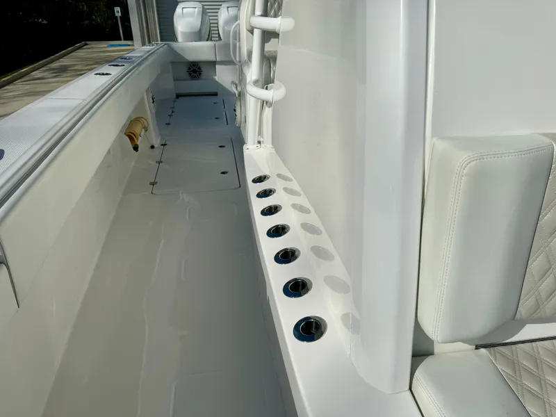 Slide: The Image of 2020 Invincible 37 Catamaran interior with rod holders and cushioned seating. - 29