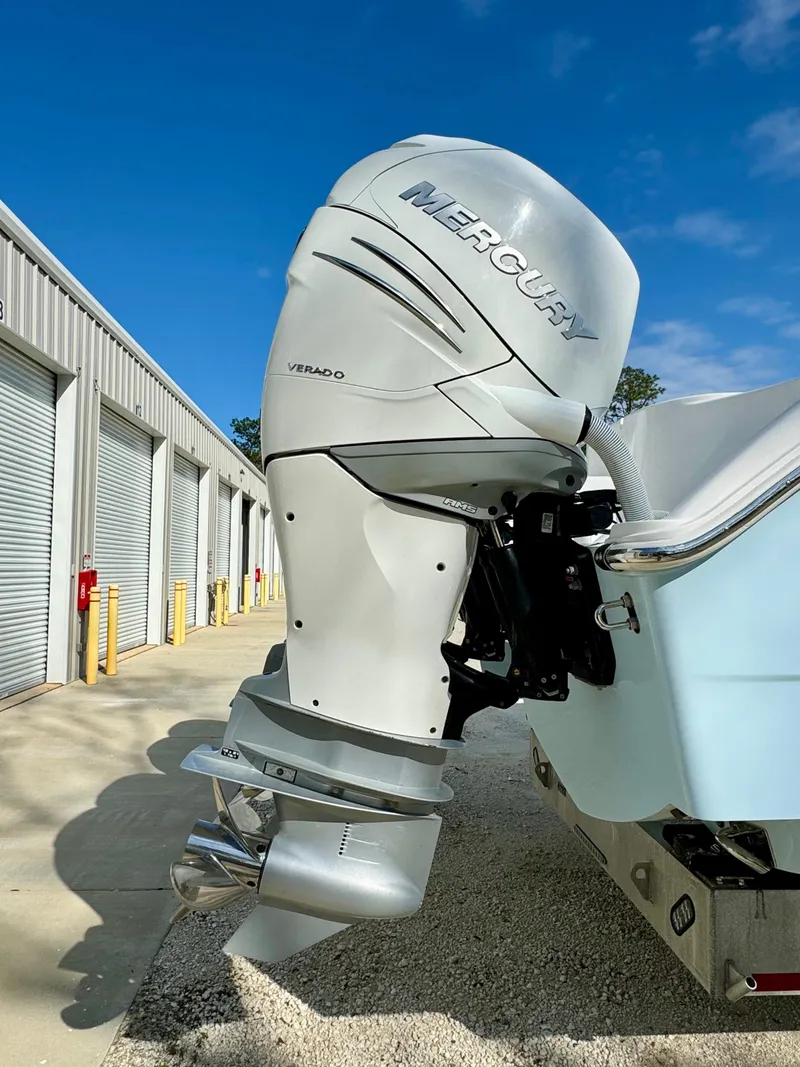 Slide: The Image of 2020 Invincible 37 Catamaran with Mercury outboard engine, parked near storage units. - 4