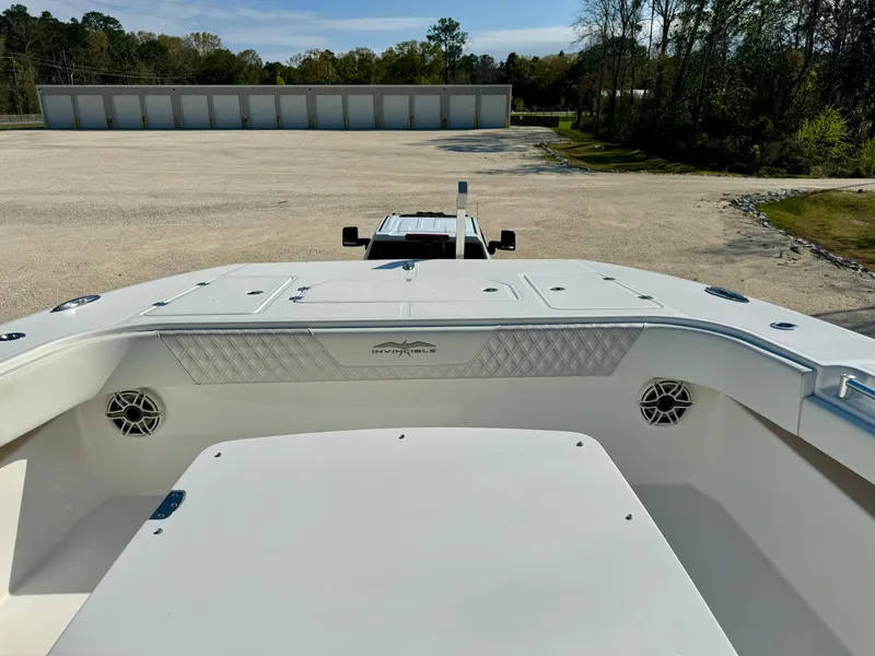 Slide: The Image of 2020 Invincible 37 Catamaran, view of deck and storage compartments, parked outdoors. - 9