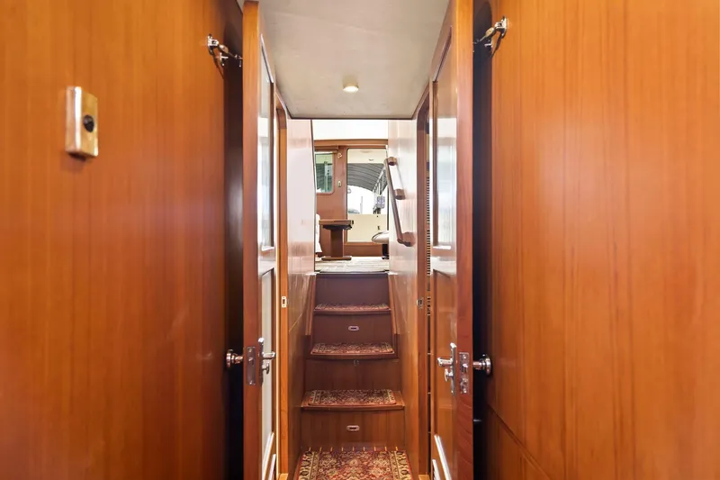 Slide: The Image of Interior hallway of 2008 North Pacific 43 Pilothouse with wooden paneling and carpeted stairs. - 19