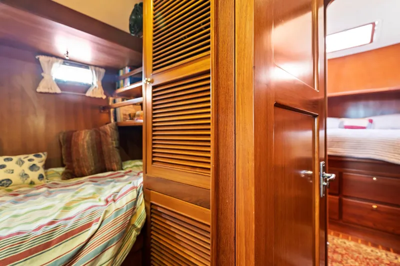 Slide: The Image of Interior of 2008 North Pacific 43 Pilothouse with cozy wooden cabin and bed. - 23