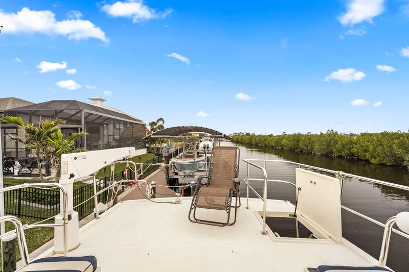 Slide: The Image of North Pacific 43 Pilothouse 2008 yacht docked by a scenic canal. - 38