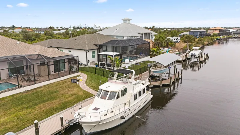 Slide: The Image of 2008 North Pacific 43 Pilothouse docked by waterfront homes. - 45