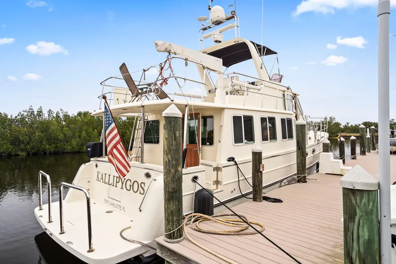 Slide: The Image of 2008 North Pacific 43 Pilothouse yacht docked with American flag. - 46