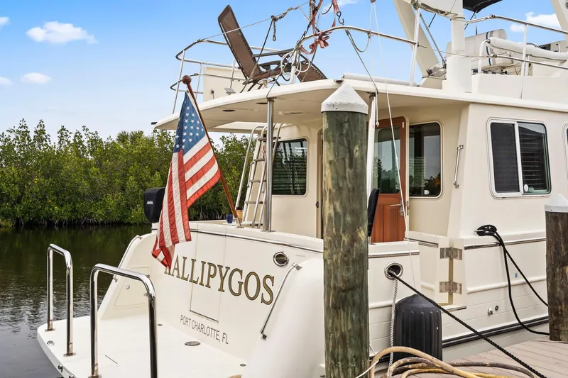 Slide: The Image of North Pacific 43 Pilothouse yacht docked, displaying American flag, 2008 model. - 47