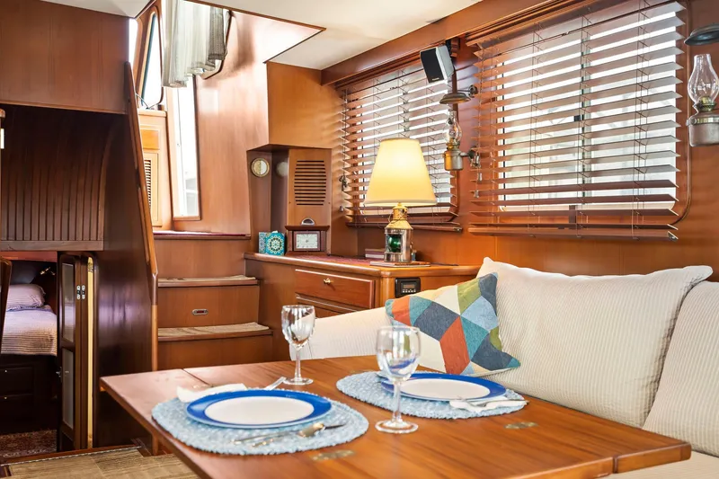 Slide: The Image of Interior of 2008 North Pacific 43 Pilothouse with dining area and cozy seating. - 9