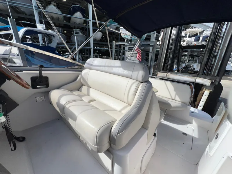 Slide: The Image of 2008 Regal 2665 boat interior with beige seating and steering area. - 10