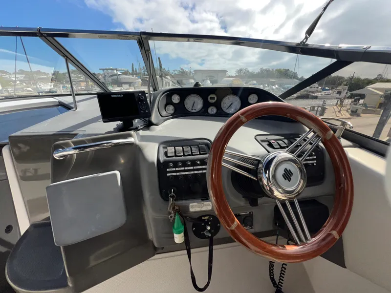 Slide: The Image of 2008 Regal 2665 boat dashboard with steering wheel and instrument panel. - 11