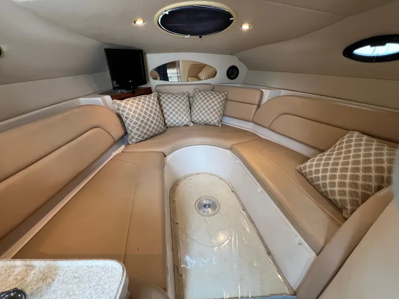 Slide: The Image of 2008 Regal 2665 boat interior with beige seating and patterned cushions. - 18