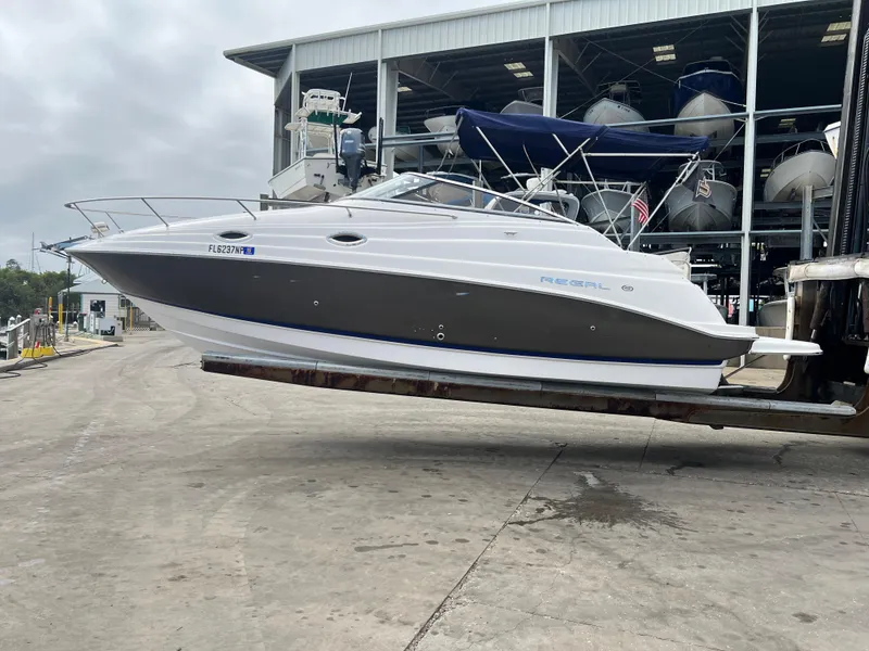 Slide: The Image of 2008 Regal 2665 boat on forklift at marina, ready for launch. - 22