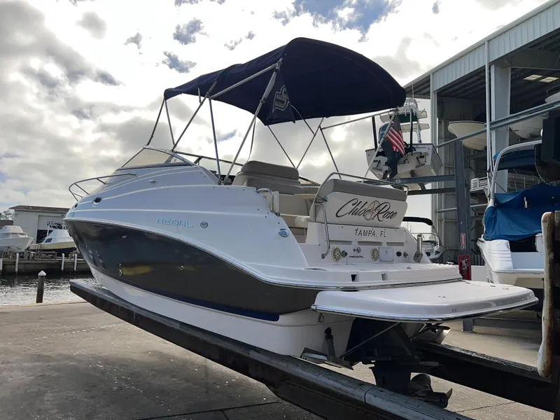 Slide: The Image of 2008 Regal 2665 boat with canopy, docked at marina under cloudy sky. - 3