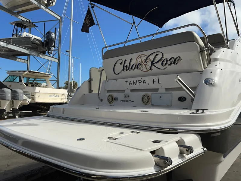 Slide: The Image of 2008 Regal 2665 boat named "Chloe Rose" docked in Tampa, FL marina. - 4