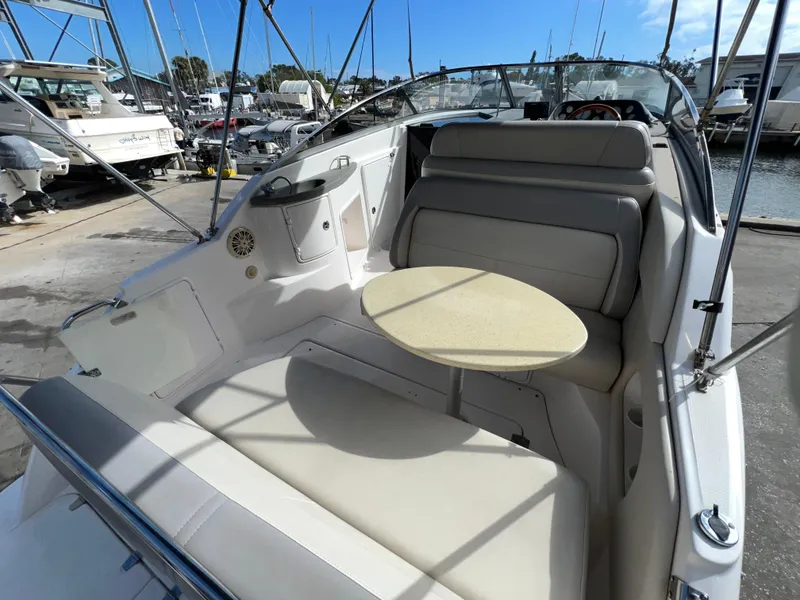 Slide: The Image of 2008 Regal 2665 boat interior with seating and table, docked at marina. - 6