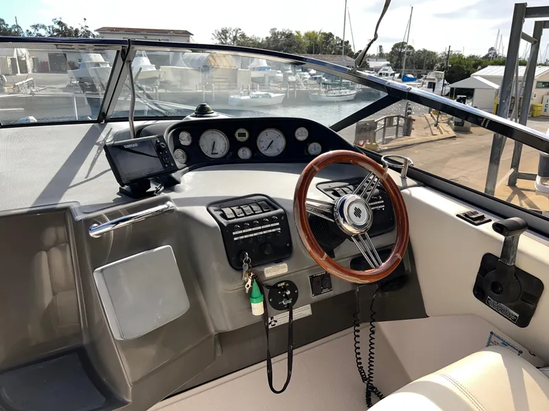 Slide: The Image of 2008 Regal 2665 boat dashboard with steering wheel and control panel. - 8