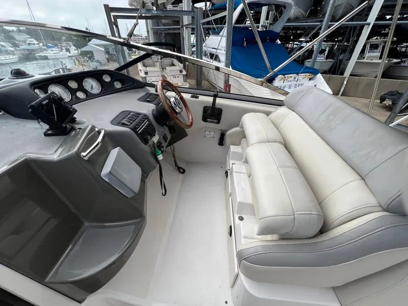 Slide: The Image of 2008 Regal 2665 boat cockpit with steering wheel and cushioned seating. - 9