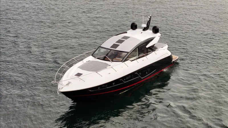 Slide: The Image of 2019 Sunseeker Predator 57 yacht on calm water, showcasing sleek design and luxury features. - 17