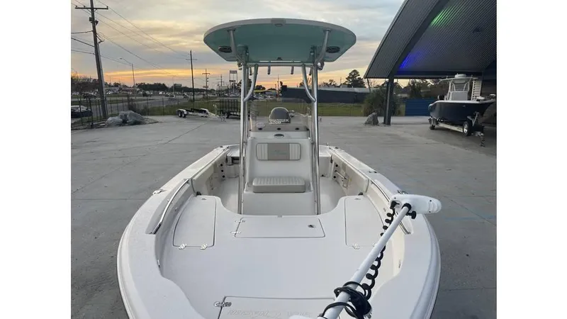 Slide: The Image of 2019 Sea Chaser 23 LX boat with T-top, docked at sunset. - 11
