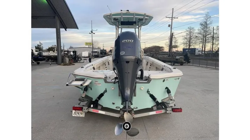 Slide: The Image of 2019 Sea Chaser 23 LX boat with outboard motor, parked outdoors. - 4