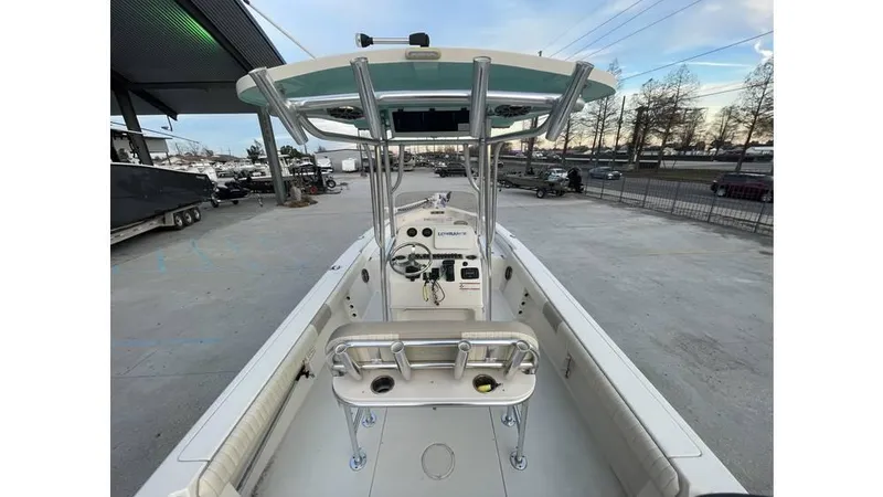 Slide: The Image of 2019 Sea Chaser 23 LX boat interior with console and seating, docked outdoors. - 6