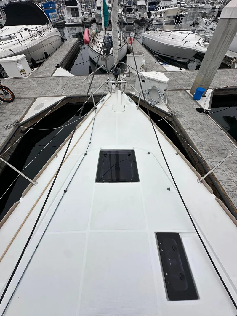 Slide: The Image of 2015 Jeanneau 41DS sailboat docked, view of deck and marina surroundings. - 14