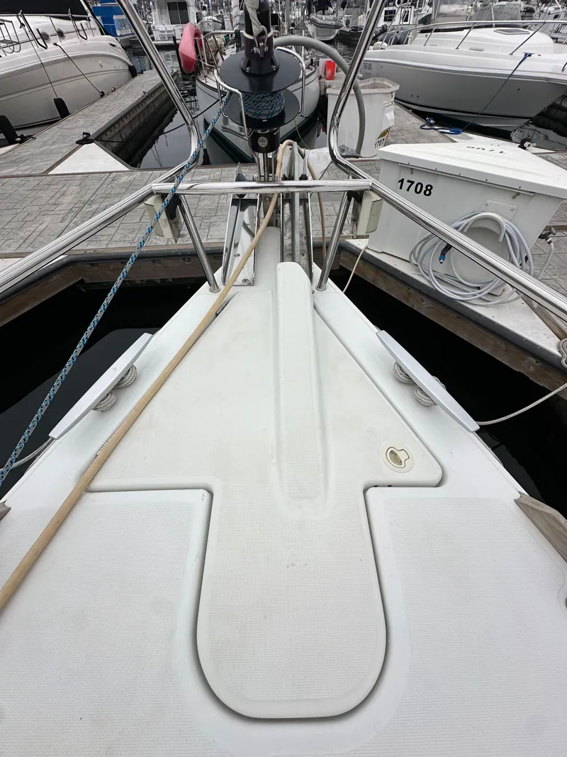 Slide: The Image of 2015 Jeanneau 41DS sailboat docked at a marina, showing the bow and deck details. - 15