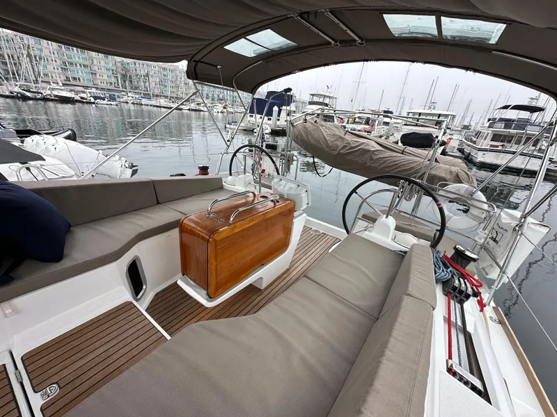 Slide: The Image of 2015 Jeanneau 41DS sailboat cockpit with seating, docked in a marina. - 27