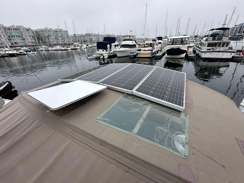 Slide: The Image of 2015 Jeanneau 41DS sailboat with solar panels docked in a marina. - 28