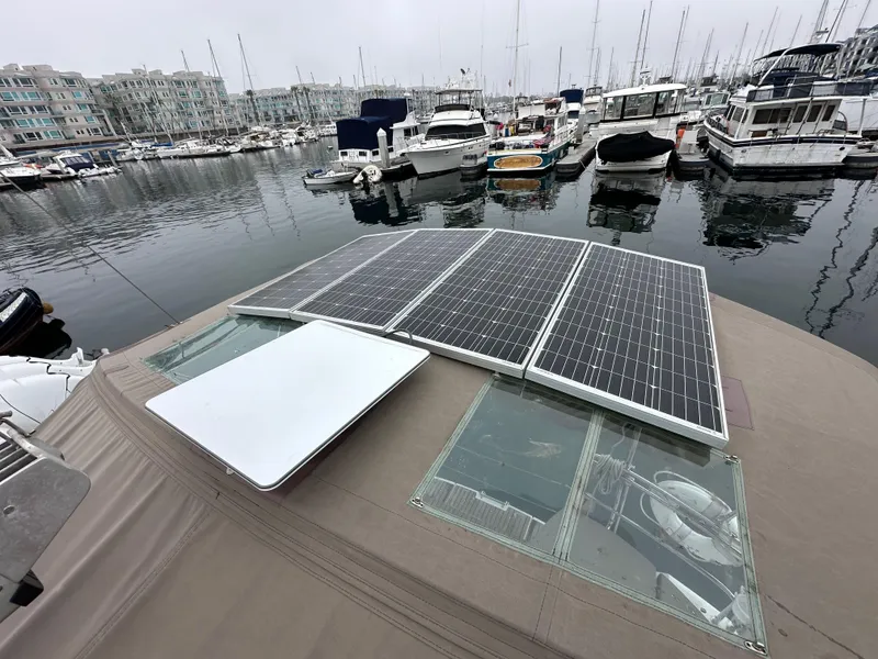 Slide: The Image of 2015 Jeanneau 41DS sailboat with solar panels docked in a marina. - 29