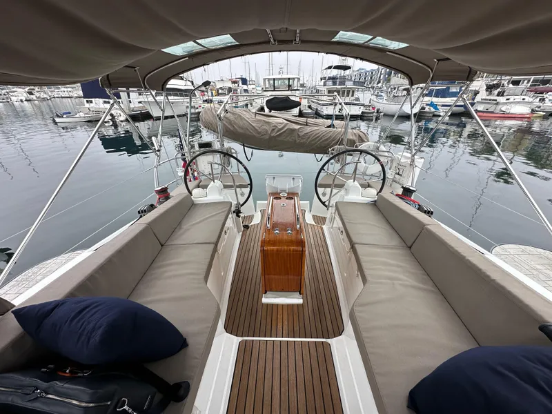 Slide: The Image of 2015 Jeanneau 41DS sailboat cockpit with dual steering wheels, docked at marina. - 30